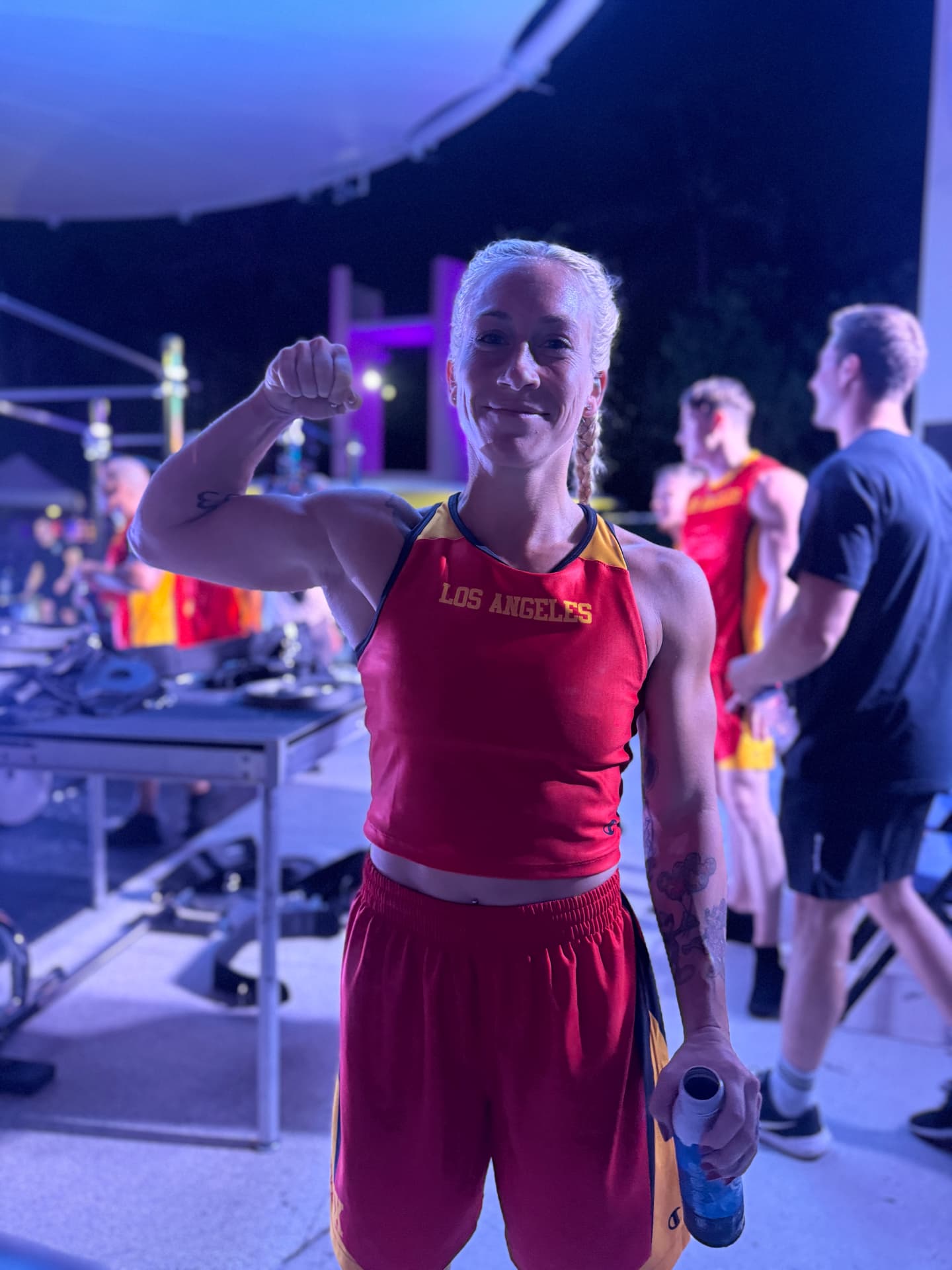 Female pro calisthenics athlete flexing after a training session